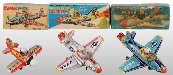 Lot of 3:Tin Airplane Friction Toys in Orig. Boxes: Japanese. Working. Includes one friction Condor piloted by a monkey and two battery-operated XF-160 US Air Force Fighter Planes. Includes all original boxes with some staining and creasing. Largest: 1