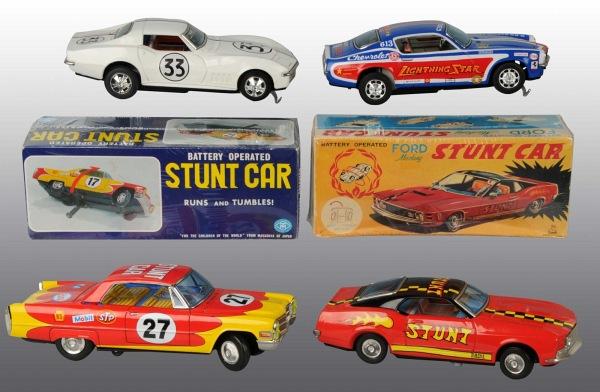 Lot of 4: Tin Race Car Battery-Operated Toys.: Japanese. Working. Includes one Ford Mustang, one Chevy Corvette, one Camaro Z28, and one Chevy Stunt car. Some overall wear. Includes two original boxes. Largest: 11" L. (Very Good).