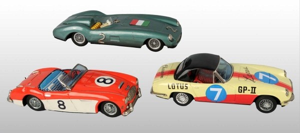 Lot of 3: Tin Bandai Race Car Friction Toys.: Japanese. Working. Includes one Austin Healey, one Ferrari, and one Lotus. Some scratching and wear. Each: 8 - 1/2" L. (Very Good).