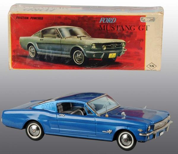 Tin Litho Ford Mustang GT Friction Toy.: Japanese. Working. Made by TN. Nice lithography of suitcase, Life magazine, and bow and arrow set in rear window. Retractable antenna. Missing left marker light, one scuff to roof, and one dent to qua