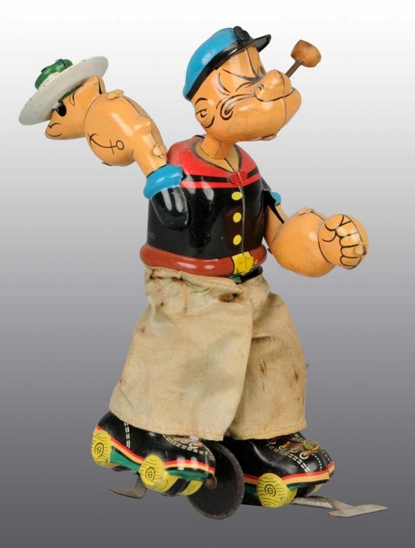 Tin Popeye the Skater Wind-Up Toy.: Japanese. Working. Marked "King Features Synd." on back. Popeye has original pipe bowl and pants. Pants are slightly soiled and faded. Rubber guide wheel on bottom has one small piece missing and a fe
