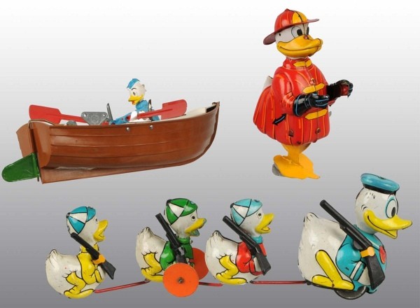 Lot of 3: Walt Disney Donald Duck Wind-Up Toys.: Includes one plastic English Tri-Ang Donald Duck and the Rowboat with tin oars, one Japanese tin Linemar Donald Duck the Climbing Fireman Figure missing ladder and base, and one Japanese tin Linemar D