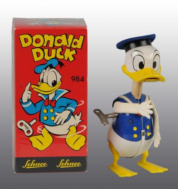 Tin Schuco Disney Donald Duck Wind-Up Toy.: German. Working. Tin body with plastic arms and beak. Original felt hat missing bow. Very little wear overall. Includes original box. 6" T. (Excellent - Near Mint).