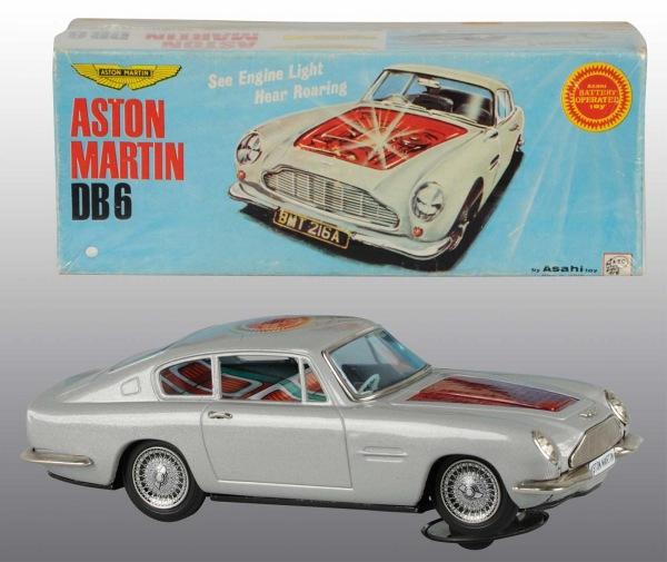 Tin Aston Martin DB6 Car Battery-Op Toy.: Japanese. Circa 1966. Working. When in operation, engine lights up and makes roaring noise. Similar to James Bond car. "Asashi" sticker on roof. Very little overall wear. Includes original box. Pictur