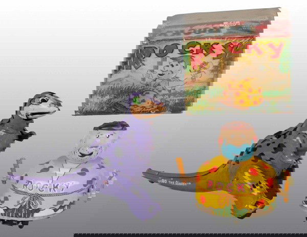 Lot of 2: Tin Litho Character Wind-Up Toys.: Japanese. Working. Includes one Dino the Dinosaur marked "Hanna-Barberra 1961" and one unlicensed Fred Flintstone battery-operated Rocky toy with original box. Box has some creasing and wear. Largest: