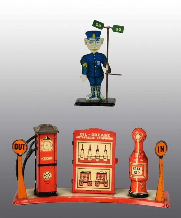 Lot of 2: Tin Marx Gas Island & Policeman Toys.: American. Gas island is missing globe and has some scratching and wear to base. Policeman's toy stop sign is missing. Largest: 9 - 1/2" L. (Very Good).