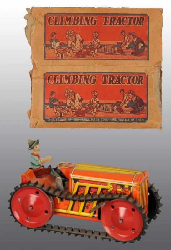 Tin Marx Climbing Tractor Wind-Up Toy.: American. Working. Original lithographed driver and rubber treads. Some minor wear to tractor. Includes partial original box with nice color graphics. 8 - 1/2" L. (Very Good).