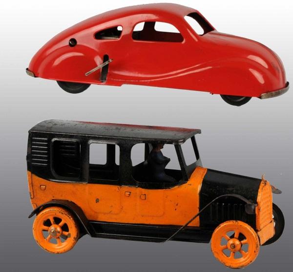 Lot of 2: Pressed Steel Automobile Toys.: American. Includes one Early Republic flywheel driven Taxi with driver and one wind-up Nylint Streamline automobile. Moderate paint loss and wear to Taxi and very little wear to Streamline auto. Large