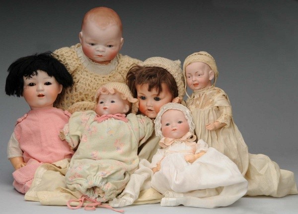Lot of 6: Bisque Baby Dolls.: Bye-Lo Baby," (cracked and repaired at lower rear of head, hand cracked), sleeping eyes; R.E. Nippon version of "Hilda", sleeping eyes, open mouth with upper teeth, brown mohair wig, composition baby 
