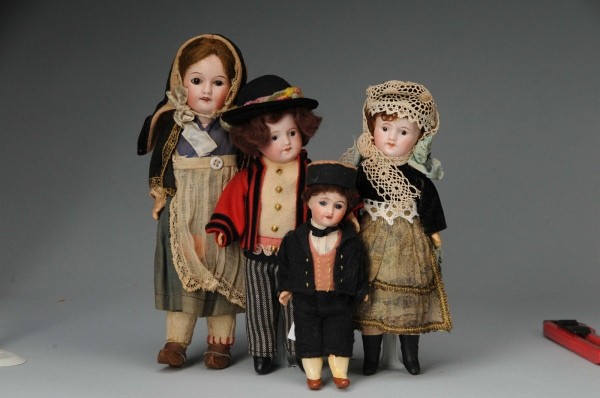 Lot of 4: French Bisque Dolls.: Paris, Ca. 1910. SFBJ 60 Pair of bisque head dolls, painted eyes, mohair wigs, 5-piece composition bodies with painted boots, all original French folk costumes. Unis 60 girl with bisque head, set glas