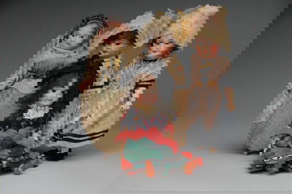 Lot of 4: French Bisque Dolls.: Paris, Ca. 1910. All have bisque heads, 3 have sleeping glass eyes, and mohair wigs, wearing original folk costumes. SFBJ 301 on 5-piece composition body (paint chips); SFBJ 60, fully jointed composit