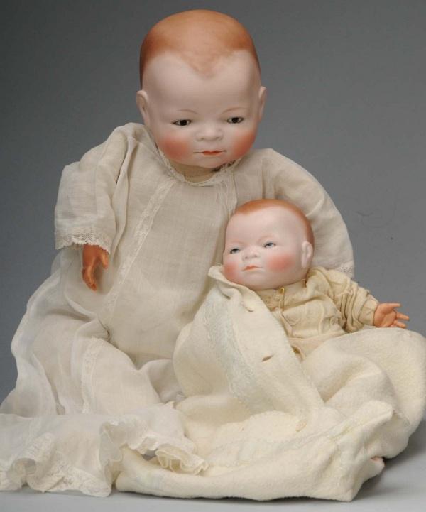 Lot of 2: Grace S. Putnam Bye-Lo Babies.: Germany/America, Ca. 1923. Bisque heads fully marked, sleeping eyes, closed mouths. Signed Bye-Lo Bodies with perfect celluloid hands. One with original baby dress, one with original underwear and bun