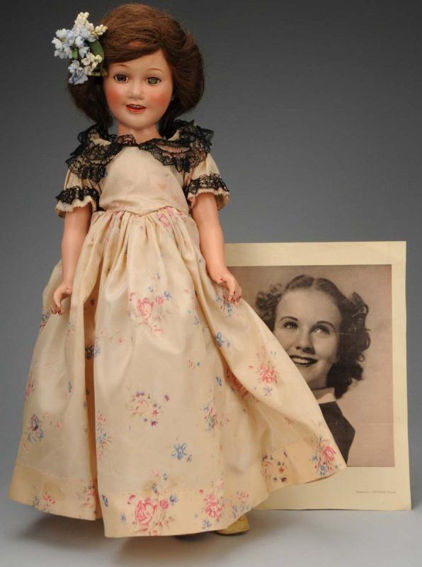 Lovely Ideal Teenage Star "Deanna Durbin".: American, 1938. All composition (light crazing on limbs), lashed sleeping eyes (one crackled), rosy cheeks, open mouth with teeth, original human hair brown wig. Factory original pink flowered rayon s