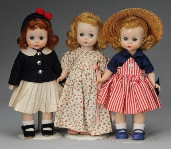 Lot of 3: Madame Alexander Plastic Wendy Dolls.: American, Ca. 1950s. All hard plastic, straight-leg walkers. #553 Wendy Carries her Milk Money, navy blue, red and white striped dress (tag cut), straw hat, panties, replaced shoes and socks; #452 Wen