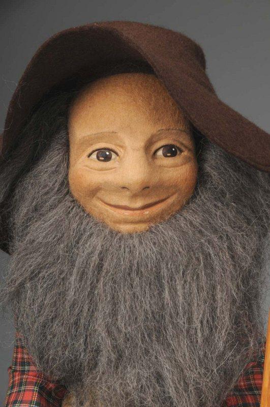 Early R. John Wright "Giuseppi".: American, Ca. 1977. All felt doll with molded character face, mohair wig and beard, jointed shoulders and hips. All original outfit with his hat and leather boots, rake accessory. Original wrist tag "