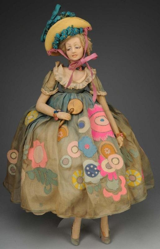 Lovely Lenci Cloth Long-limbed Lady Doll.: Italian, Ca. 1920s. Molded felt face with "bedroom" eyes, open mouth with painted teeth, blonde mohair wig with curls in back, organdy dress (some fading overall and tear on front skirt), with felt ap