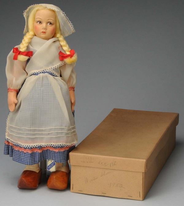 Lovely Lenci-Type All Felt Child Doll.: Italy, Ca. 1940-1950s. Molded felt face with brown side-glancing eyes, blonde braids, all original folk costume with blue cotton dress, white apron and hat (some small holes in apron), wooden shoes. S