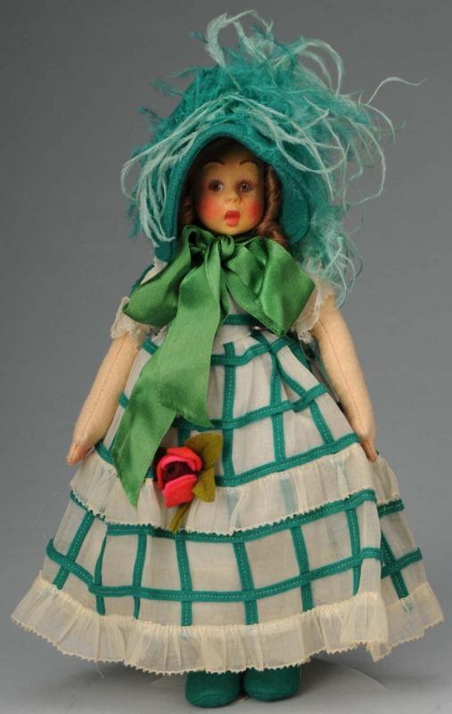 Lovely Lenci Mascotte Girl with Fancy Hat.: Italy, Ca. 1930s. All cloth with brown side-glancing eyes, rosy cheeks, light brown mohair wig with long curls, totally original in organdy dress with green felt stripes, green hat, and pink felt rose