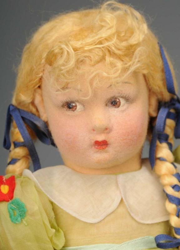 Cloth Lenci Girl with Lucia Face.: Italy, Ca. 1930s. Molded felt face (some discreet restoration) with beautifully detailed brown side-glancing eyes, rosy cheeks, blonde mohair wig with braids entwined with ribbons. All original in org