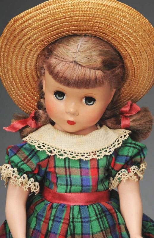 Lovely Madame Alexander "Polly Pigtails".: American, Ca. 1949. All hard plastic with Maggie face, light brown floss braids, lashed blue sleeping eyes, rosy cheeks, closed mouth. Tagged green cotton print dress, undies, shoes and socks, straw h