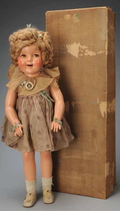 Boxed Ideal Child Star "Shirley Temple".: American, Ca. 1930s. All composition (several short craze lines on face and 1" crack below her ear), fully marked on head and body. Original mohair wig in original set with hair bow, flirty sleep eyes
