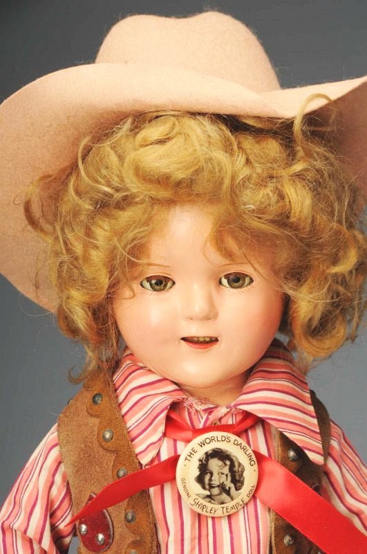 Ideal Composition Child Star "Shirley Temple".: American, Ca. 1935. All composition (craze line by one eye, compo needs to be cleaner), original blonde mohair wig (mussed), clear hazel lashed sleeping eyes. Original leather cowgirl chaps and vest, 