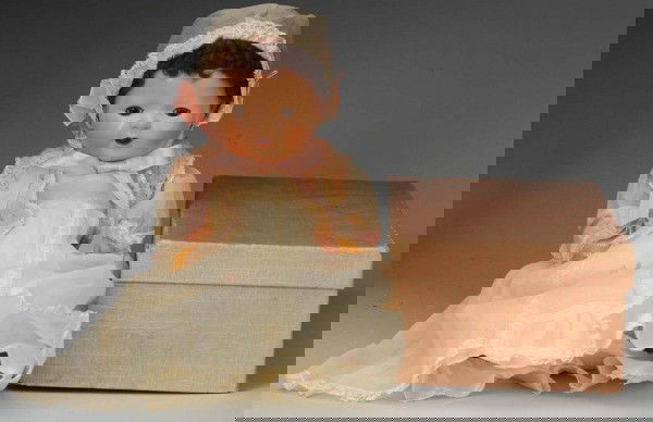 Early Effanbee "Dy-Dee Baby" in Original Box.: American, Ca. 1930s. All rubber with dark caracul wig, lashed brown sleeping eyes, open mouth with tongue. Wearing tagged lovely original organdy christening gown with lace trim, slip, diaper, hat and