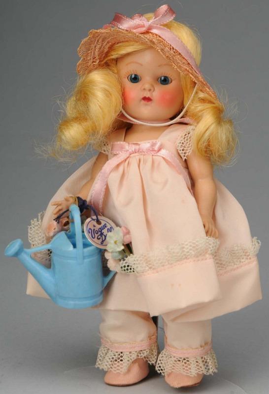 Sweet Vogue Hard Plastic "Ginny".: Ca. 1950s. American. Painted lash, strung doll, original curly blonde wig, rosy cheeks, blue sleeping eyes, totally original in pink taffeta outfit with matching hat, socks and center-snap shoes, roun