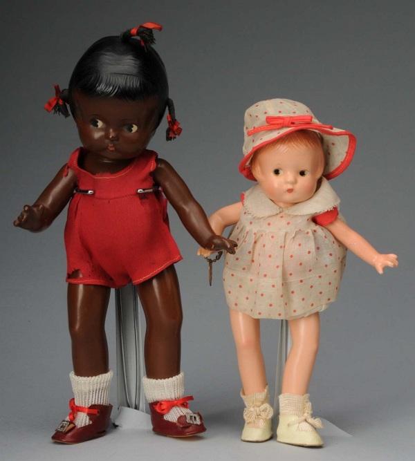 Lot of 2: Effanbee Patsy Family Dolls.: American, Ca. 1930s. All composition. Very rare Patsy Jr. black doll, black molded hair with 3 inserted yarn pigtails, painted side-glancing eyes, tagged red silk dress and undergarment (deteriorating