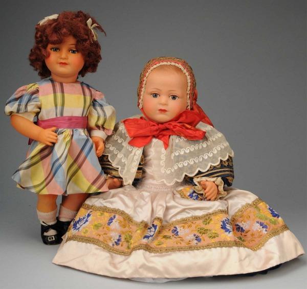 Lot of 2: SNF Celluloid Dolls.: France, Ca. 1930-40s. Both with beautiful high color. Toddler girl with inset lashed eyes, curly auburn wig, closed mouth, original dress and undies. Very desirable rare large size baby with molded ha