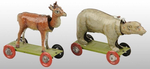 Lot of 2: Tin Litho Animal Penny Toys.: German. Includes one polar bear and one deer, both on wheeled platforms with nodding heads. Some minor overall wear. Largest: 2 - 3/4" T. (Very Good - Excellent).