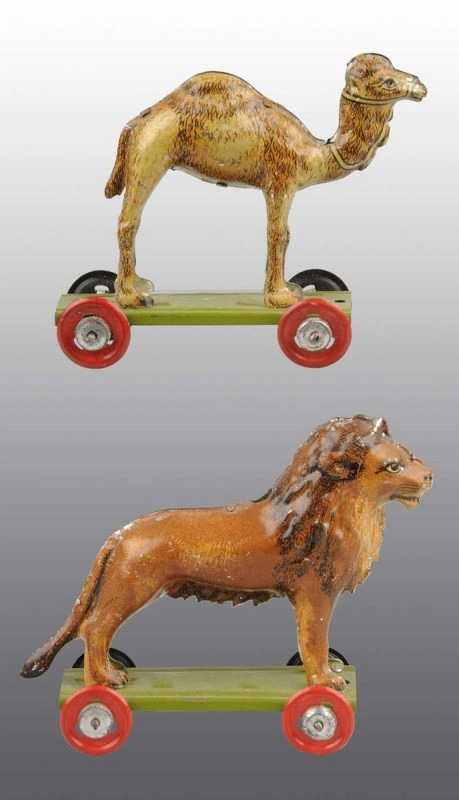 Lot of 2: Tin Litho Animal Penny Toys.: German. Includes one camel and one lion on wheeled platform. Some minor scratching and wear. Largest: 2 - 1/2" T. (Very Good - Excellent).