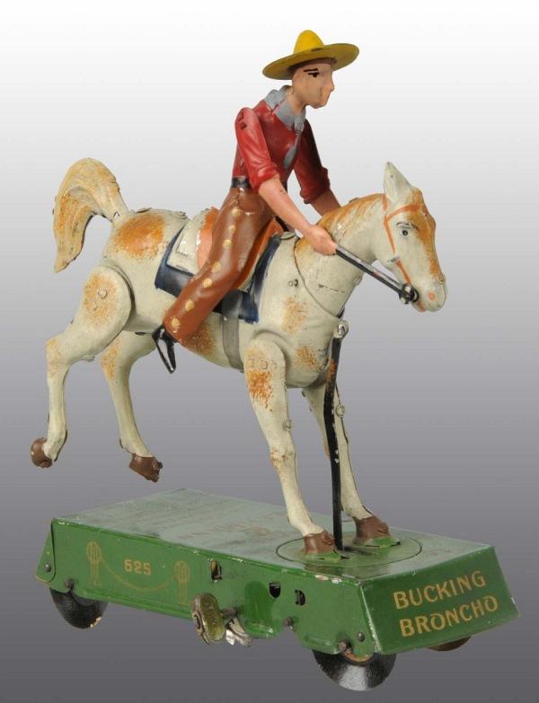 Tin Litho Lehmann Bucking Bronco Wind-Up Toy.: German. Working. White horse variation. Marked "DRGM" on sides, "Bucking Bronco" on front, and "Lehmann" on top of platform. Some scratching and wear. 7 - 1/2" T. (Very Good - Excellent).
