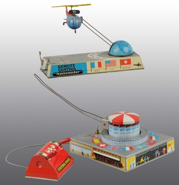 Lot of 2: Tin Litho Air Wind-Up Toys.: German. Working. Marked "Made in Western Germany". Includes one Trans World Flyer and one Helicopter Toy. Includes both original boxes, one with half of side flap missing. Largest: 8 - 1/4" L. (Very G
