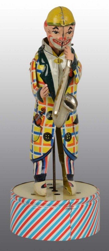 Tin Litho Clown Saxophone Player Wind-Up Toy.: German. Working. Made by Distler. Nice colorful lithography. Very little wear overall. 8 - 1/2" T. (Excellent - Near Mint).