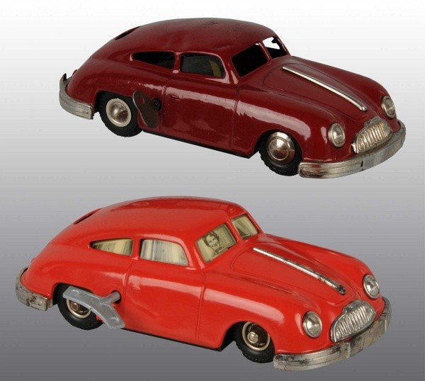 Lot of 2: Tin Porsche Automobile Wind-Up Toys.: German. Made by Gescha. Working. Marked "Made in Western Germany". Both with dial discs on bottom for steering. One has a lithographed woman driver in front window and is repainted the other has a den