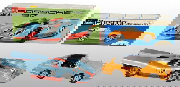 Lot of 2: Tin Litho Schuco Race Car Toys.: German. Working. Includes one wind-up Porsche Targa 911S and one battery-operated Porsche 917 Race Car with gullwing doors. Includes both original boxes. Largest: 11" L. (Near Mint).