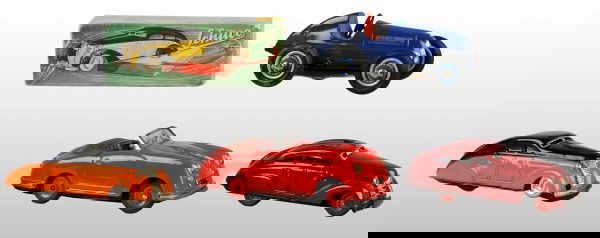 Lot of 4: Tin Schuco Automobile Wind-Up Toys.: German. Working. Includes one no. 1010 with original box, one Magico no. 2008, one Sport Examico, and one Race Car. Very little wear overall. Largest: 5 - 3/4" L. (Excellent).