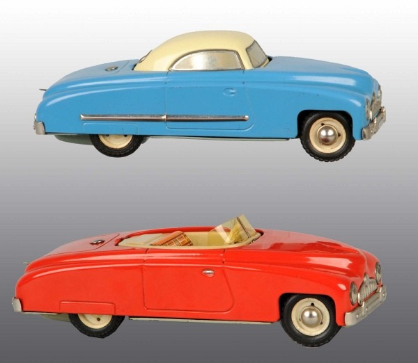 Lot of 2: Tin Automobile Wind-Up Toys.: German. Made by CKO. Working. Both are flip-top cars which change from a convertible to a sedan, one with composition driver. Minor scratching and wear. Largest: 9" L. (Excellent).