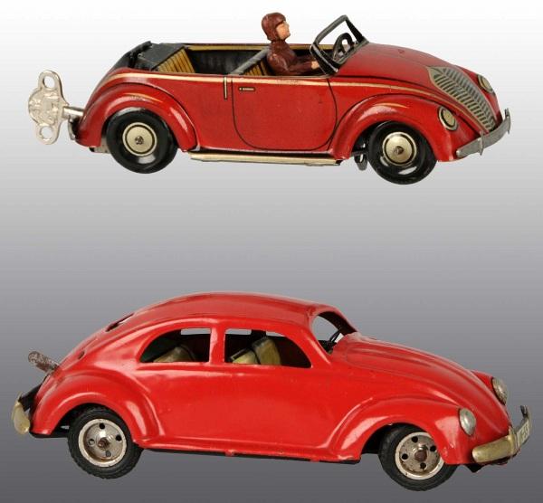 Lot of 2: Tin Volkswagen Vehicle Wind-Up Toys.: German. Working. Both marked "US Zone Germany". Includes one split window Volkswagen Coupe and one flip-top car marked "CKO" that changes from coupe to convertible with composition driver. Largest: 7"