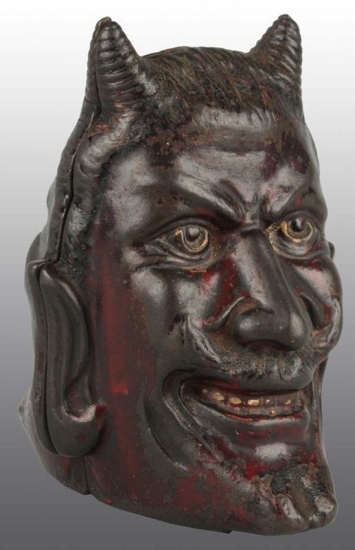 Cast Iron Two Faced Devil Still Bank.: Circa 1904. Manufactured by A.C. Williams. 4 - 1/2" T. (Excellent).