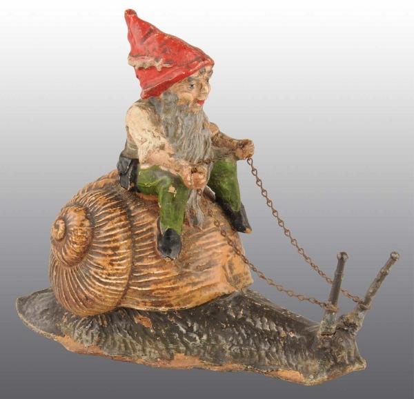 Elastolin Elf Riding Snail Still Bank.: Manufactured in Germany. Beautiful detail. 5" L. (Near Mint).