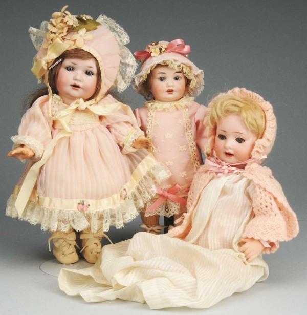 Lot of 3: German Bisque Character Dolls.: Revalo, sleeping eyes, open mouth with molded teeth, 5-piece baby body (cracking); 2 A.M. 971, sleeping eyes, open smiling mouth, 5-piece composition toddler bodies (wear on fingers, discoloration on 