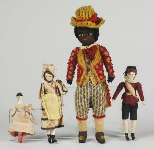 Lot of 4 Antique Cloth Dolls.: Worsted" doll with black stockinette face, black bead eyes, embroidered features, black curly wool hair, stuffed body with pants, shoes and stockings an integral part of body; vest, and coat are added