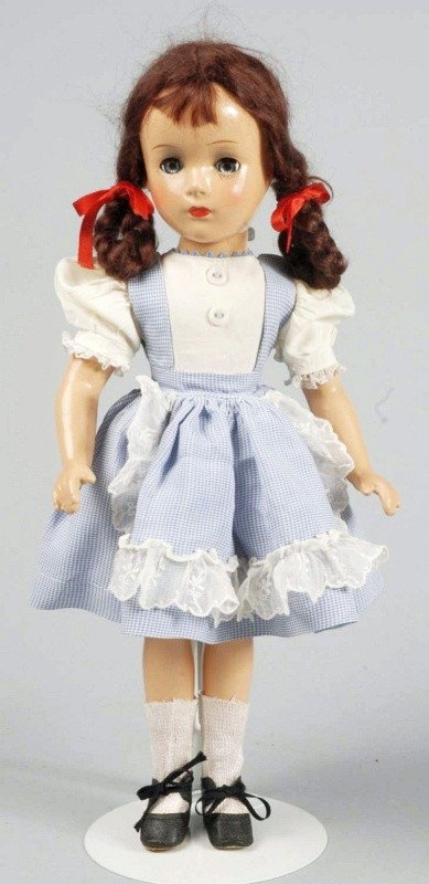 Madame Alexander Child Star "Margaret O'Brien".: All composition (overall light crazing) with clear hazel lashed sleeping eyes, gray eye shadow, rosy cheeks, auburn mohair wig with bangs and braids, original tagged "Madame Alexander" dress with atta