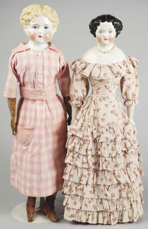 Lot of 2 German China Head Dolls.: Alt, Beck & Gottschalck 1880s blonde china shoulder head child with short curly hair, exposed ears, large blue painted eyes, white dot highlight, brown one-stroked eyebrows, red eyelid line, black eye