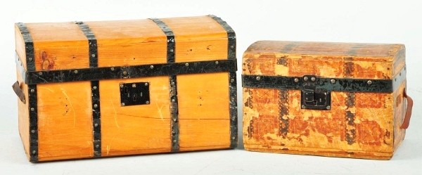 Lot of 2: Antique Doll Trunks.: Natural wood finish with ten decorative strips, leather handles, original papered inside, tray with cardboard lid, covered compartment in trunk lid; smaller paper covered wood trunk (some loss to pape