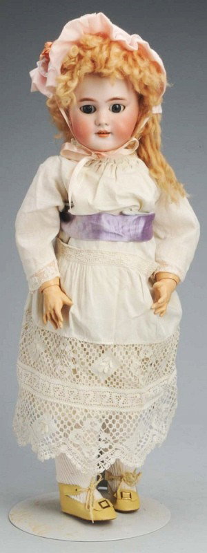 Jumeau French Bisque Bébé Doll.: DEP mark, blue sleeping eyes, molded eyebrows, pierced ears, open mouth with teeth, new mohair wig, jointed composition and wood French body (repainted). 20" T. (Very Good).