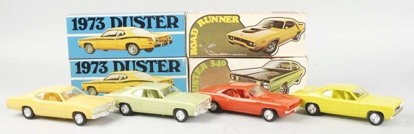 Lot of 4: Promotional Muscle Car Toys.: Circa 1970s. Includes three Plymouth Dusters and one Roadrunner. Includes all original boxes with nice color graphics. Size: Each: 9" L.
