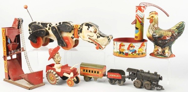 Lot of 6: Toys & Trains.: American. Includes one wind-up train set with engine, tender, and one car, one Marx Whoopee car with broken horn, and other various toys. Train set with some overall bending and missing one set of whe